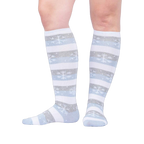 Lifestyle shot showing the socks on a person's legs against a light background.