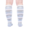 Rear view of the socks on a person's legs against a light background.
