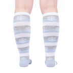 Rear view of the socks on a person's legs against a light background.