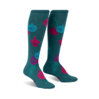 Pair of teal knee-high socks adorned with pink, teal, and blue ornaments and green sprigs.