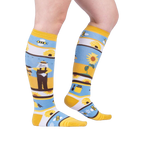 Lifestyle shot: A model's legs wearing the 'Honey, You're a Keeper' knee-high socks.