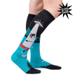 Lifestyle photo showcasing the 'Out of Boaty Experience' glow-in-the-dark socks on a model's legs.