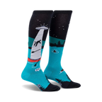 Pair of teal and black knee-high socks depicting a humorous alien abduction scene on a lake at night.  The socks glow in the dark.