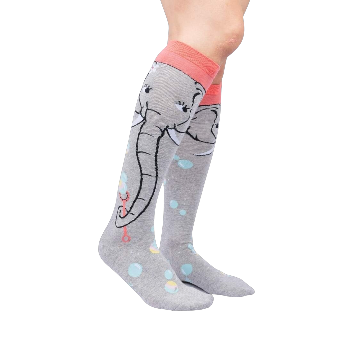 Lifestyle shot: Model wearing a pair of grey and coral knee-high socks with an elephant and bubble design.