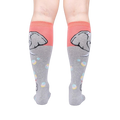 Rear view of a pair of grey and coral knee-high socks with an elephant and bubble design.