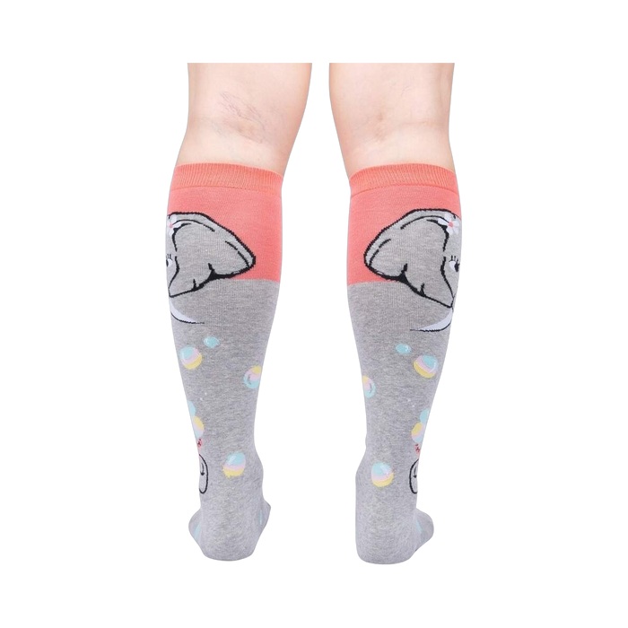 Rear view of a pair of grey and coral knee-high socks with an elephant and bubble design.