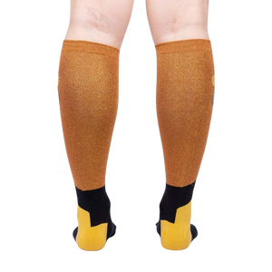 A pair of gold and black knee-high socks with a geometric pattern displayed on the back of the leg.
