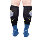 Rear view of Disco Nut! socks on a person's legs; highlighting the full sock design and color scheme.