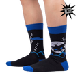 Lifestyle photo showing the socks on a person's legs, highlighting their fit and glow-in-the-dark feature.