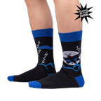 Lifestyle photo showing the socks on a person's legs, highlighting their fit and glow-in-the-dark feature.