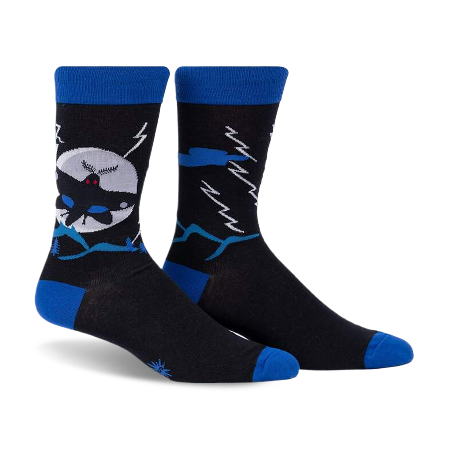 Crew socks in black and blue, featuring a Mothman design against a moonlit, mountainous scene.  They glow in the dark!
