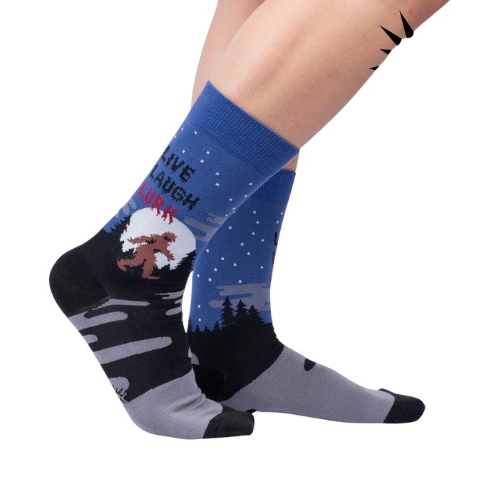 Lifestyle shot: Model wearing the 'Live, Laugh, Lurk' socks, showcasing their fit and design.