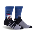 Pair of crew socks in blue, gray, and black, showing a Bigfoot design in a snowy forest scene with the text 'Live, Laugh, Lurk'.