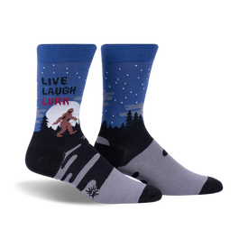 blue crew socks featuring bigfoot silhouette, fir tree pattern and text 'live, laugh, lurk'.  