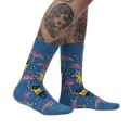 Lifestyle shot showcasing the 'Petting in the Rain' socks on a model's legs.
