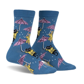 a front view of a pair of blue socks with a pattern of black cats wearing yellow raincoats and holding pink umbrellas. the socks have a white background with white raindrops.