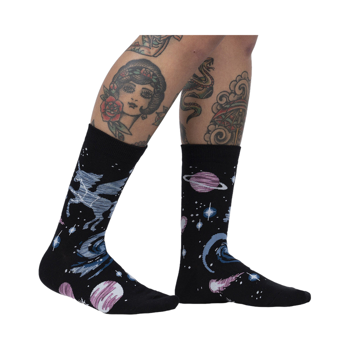 Lifestyle shot of Ancient Pegasus socks on a model's legs, showcasing the sock design and fit.