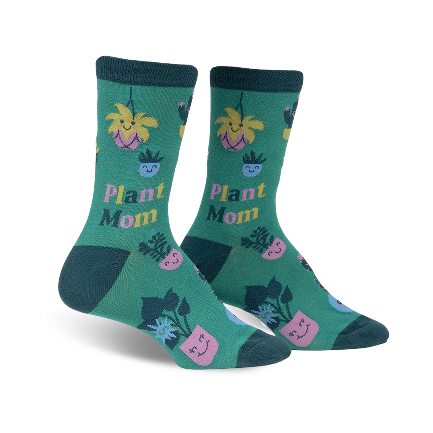 Pair of women's crew socks. Green background with illustrations of potted plants, cacti, and flowers with happy faces. Text reads 'Plant Mom'.