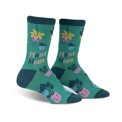 women's knee-high crew socks in dark green with pink, blue and yellow pots and smiley-face plants.   