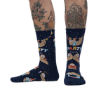 Lifestyle photo showing the socks on a person's legs, showcasing the sock's fit and design on a model with tattoos.