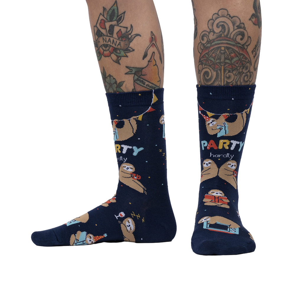 Lifestyle photo showing the socks on a person's legs, showcasing the sock's fit and design on a model with tattoos.
