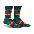 Crew socks in teal with a repeating pattern of retro sunset hearts featuring Sasquatch silhouettes and pine trees.
