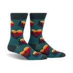 Crew socks in teal with a repeating pattern of retro sunset hearts featuring Sasquatch silhouettes and pine trees.