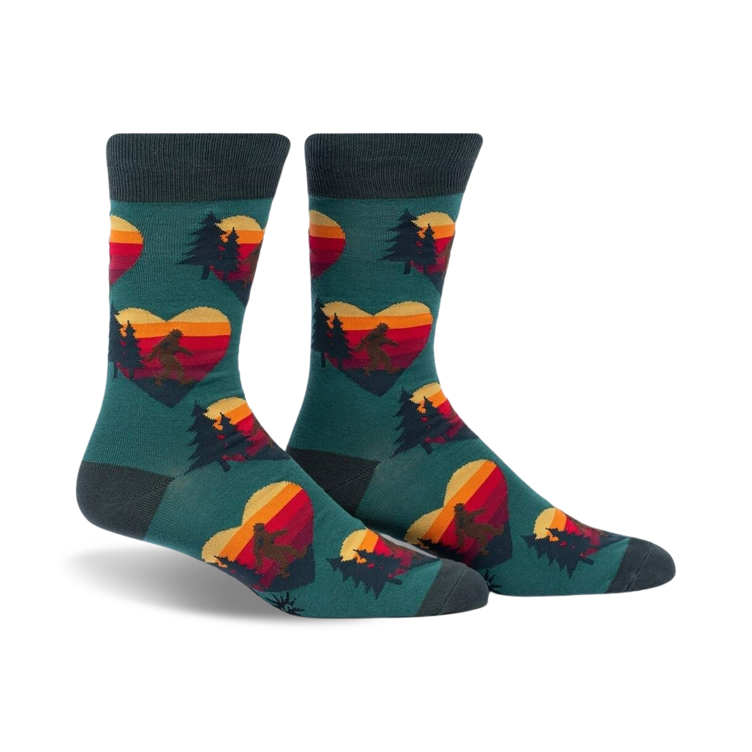 Crew socks in teal with a repeating pattern of retro sunset hearts featuring Sasquatch silhouettes and pine trees.