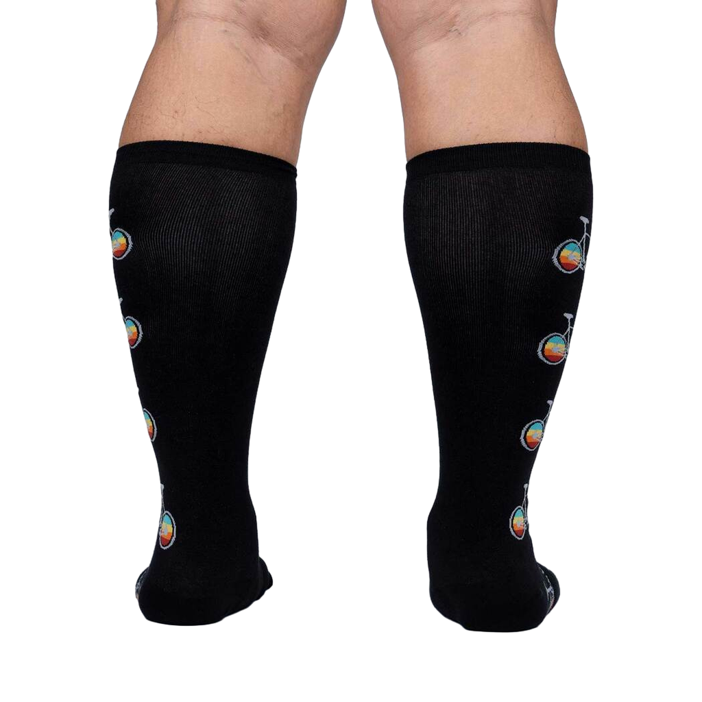 Rear view of Pedal Power socks on a model, highlighting the full design placement on the back of the legs.