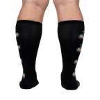 Rear view of Pedal Power socks on a model, highlighting the full design placement on the back of the legs.