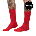 Close-up on a person's legs wearing red crew socks with maroon fuzzy hearts. 