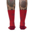 Back view of a person's legs wearing red crew socks with maroon fuzzy hearts.
