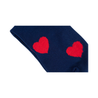 Flatlay image of a pair of navy blue crew socks with red fuzzy hearts.