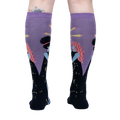 Rear view of model wearing a pair of Cosmic Connection knee-high socks.