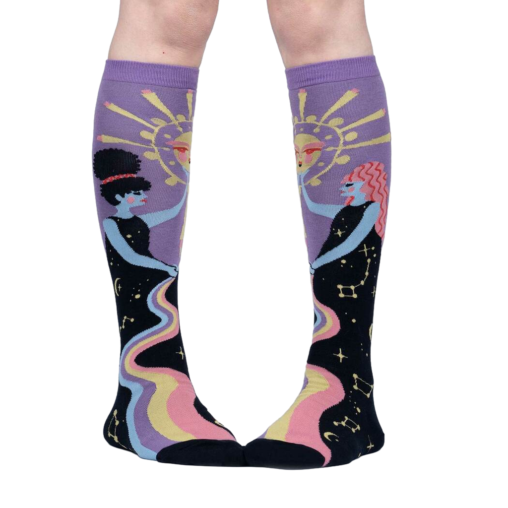 Close-up of model's legs wearing Cosmic Connection knee-high socks.