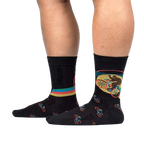 Lifestyle shot of Bike-Squatch socks on a person's legs. Shows the socks' fit and design in action.
