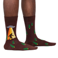 Lifestyle shot of a person wearing the Bigfoot and UFO crew socks. Shows how the socks look on.
