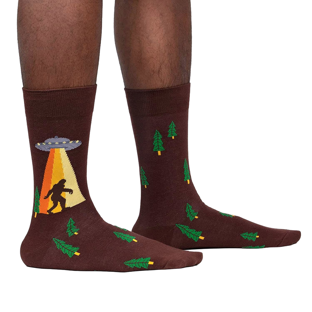 Lifestyle shot of a person wearing the Bigfoot and UFO crew socks. Shows how the socks look on.