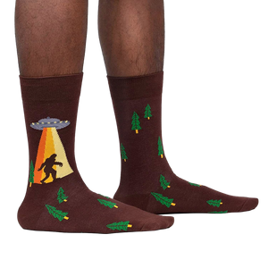 Lifestyle shot of a person wearing the Bigfoot and UFO crew socks. Shows how the socks look on.