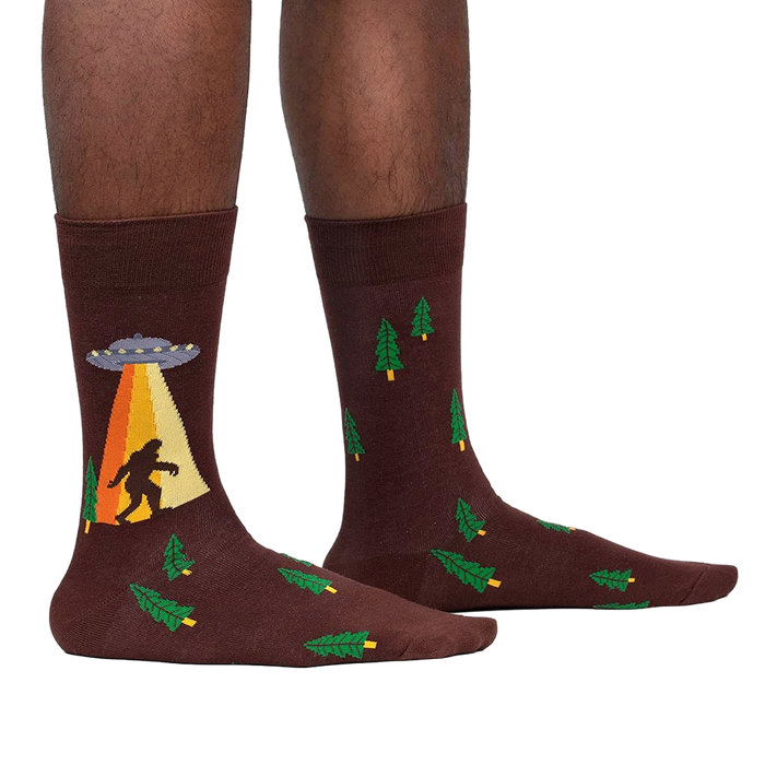 Lifestyle shot of a person wearing the Bigfoot and UFO crew socks. Shows how the socks look on.