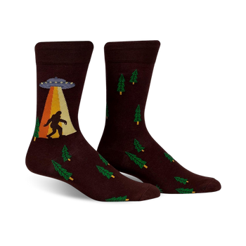 mens brown crew socks with green pine tree pattern, bigfoot and ufo graphic   
