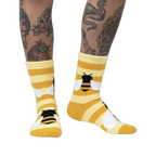 Lifestyle photo showing the Bee Cozy Slipper Socks on a person's legs.