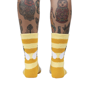 Back view of the Bee Cozy Slipper Socks on a person's legs.