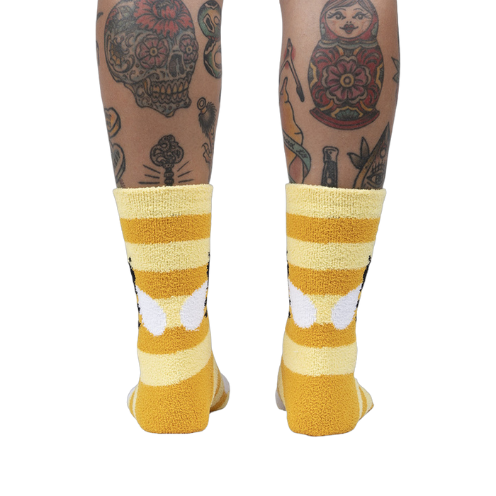Back view of the Bee Cozy Slipper Socks on a person's legs.