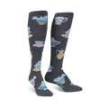 Pair of knee-high socks in dark gray featuring a pattern of manatees relaxing in pastel teacups and teapots.