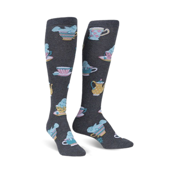 Pair of knee-high socks in dark gray featuring a pattern of manatees relaxing in pastel teacups and teapots.