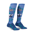 Pair of knee-high socks in blue featuring pandas, sloths, and green leaves on a soft blue background.
