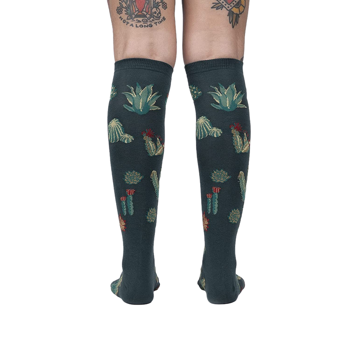 Back view of the Cactus Jungle knee-high socks on a person's legs, showing the design's full coverage.