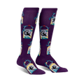 Pair of purple knee-high socks with a repeating pattern of fairies in mason jars, accented with teal and yellow.