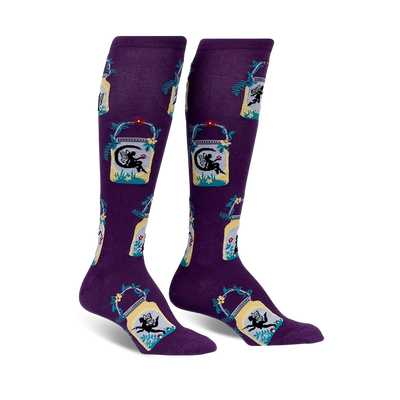 knee-high purple socks with a pattern of fairies, lanterns, leaves, and vines  